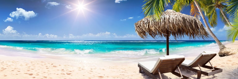 Beach umbrella with deck chairs in Indian Ocean